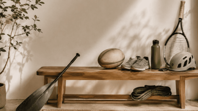 Sporting equipment laid out on a bench